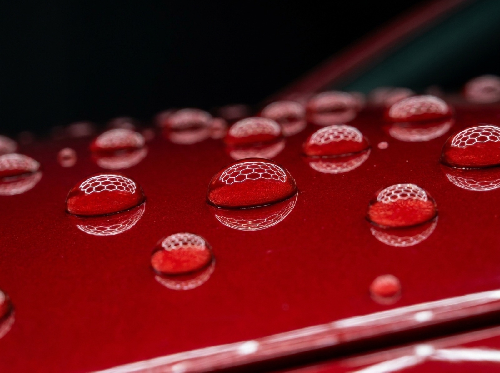 Water beading on a ceramic-coated red panel